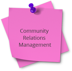 A pink post it note with the words community relations management on top.