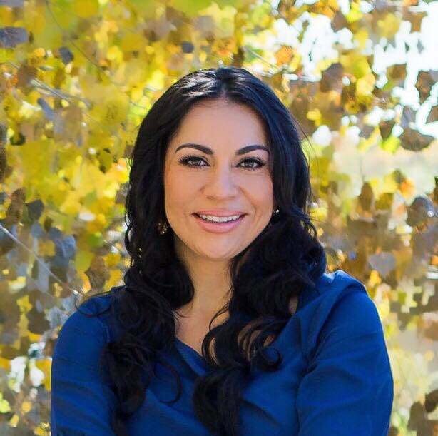 Joelle Delgado A woman with long black hair wearing blue shirt.