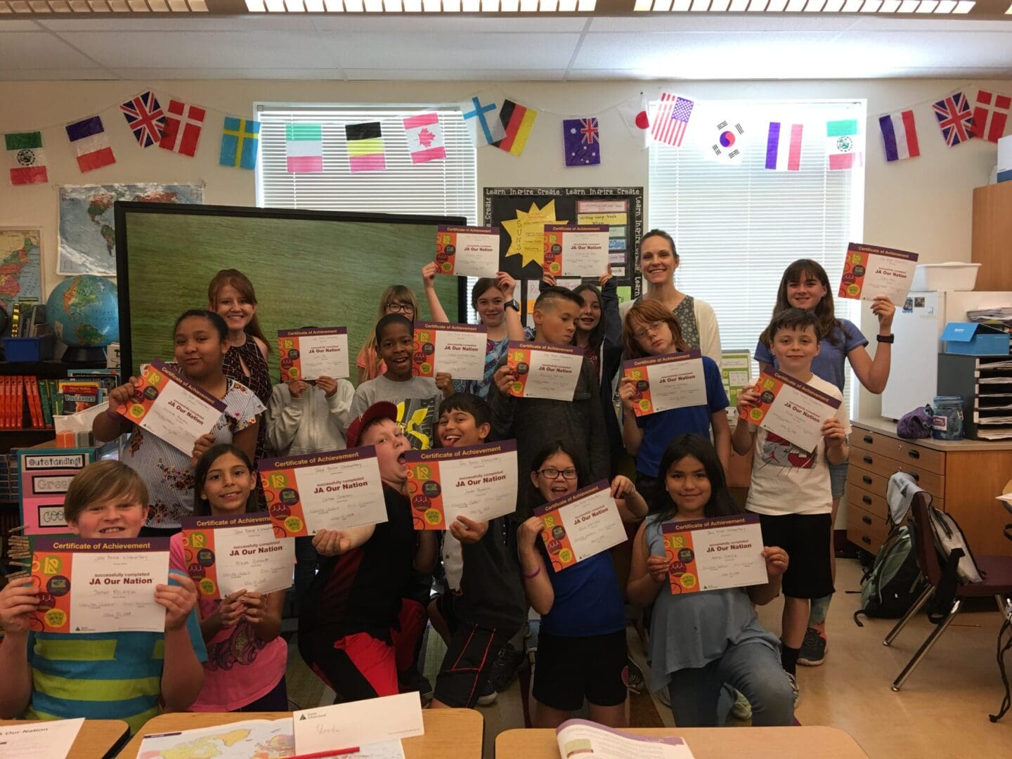 A group of so many children holding certificates.